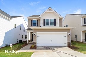 Simpsonville house for rent - A house with a garage and a driveway in front of it.