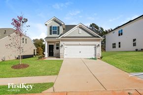Greer house for rent - A house with a grey roof and a white garage door is for sale.