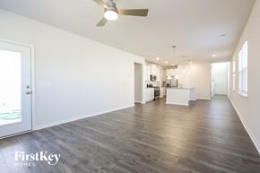 Greer house for rent - A spacious room with a kitchen area in the background and a ceiling fan above.