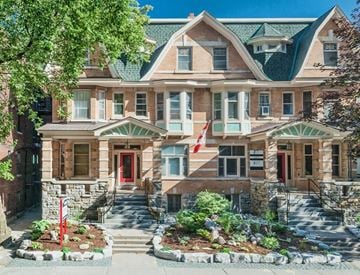 Ottawa apartment for rent - a large house with a red door and a flag on the front