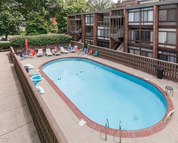 Louisville apartment for rent - A large outdoor swimming pool surrounded by a brick wall.
