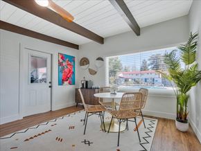 Santa Rosa apartment for rent - a dining room with a table and chairs and a large window