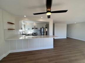 Nanaimo apartment for rent - A modern kitchen with a wooden floor and a ceiling fan.