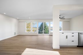 Nanaimo apartment for rent - A spacious room with a large window and a wooden floor.