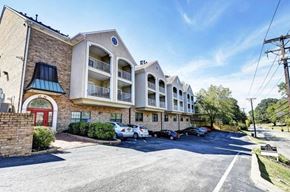 Louisville apartment for rent - A sunny day at the Hearth Apartments with cars parked in the lot.