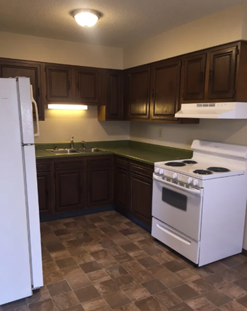 Highland apartment for rent - a kitchen with a stove refrigerator and a sink