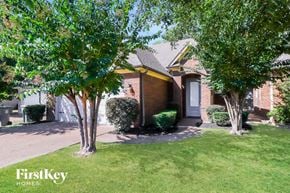 Memphis house for rent - A house with a lawn and trees in front of it.