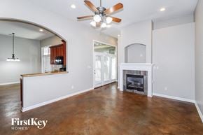 Memphis house for rent - A living room with a fireplace and a ceiling fan.