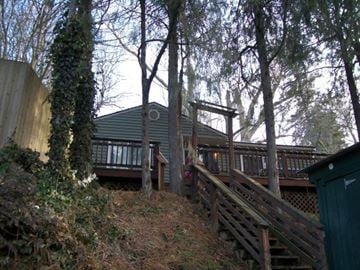 Pullman apartment for rent - A house with a deck and stairs leading up to it.
