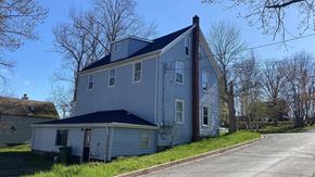 Pictou apartment for rent - a gray house with a black roof on the side of a street
