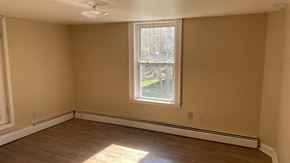 Pictou apartment for rent - an empty room with a window and wooden floors