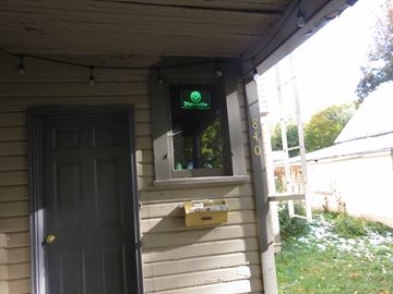 Pullman apartment for rent - A green sign on a house reads "Telecommunications".