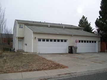Pullman apartment for rent - A two-car garage with a white door and a brown roof.