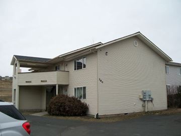 Pullman apartment for rent - A beige house with a garage and a car parked in front.