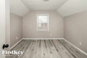 Kansas City house for rent - a spacious room with hardwood floors and a window