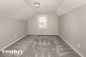 Kansas City house for rent - a bedroom with a carpeted floor and a window