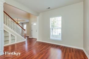 Winston-Salem house for rent - A room with wooden floors and a staircase.