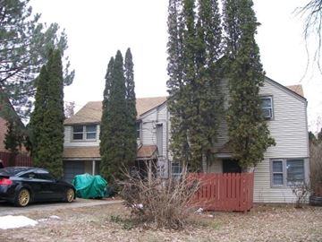 Pullman apartment for rent - A black car is parked in front of a house.