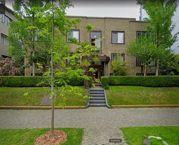 Vancouver apartment for rent - A tree in a small garden in front of a building.