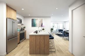 Kelowna apartment for rent - A modern kitchen with a wooden island and stainless steel appliances.