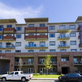 Langford apartment for rent - A white pickup truck is parked in front of a two-story apartment building.