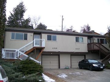 Pullman apartment for rent - A two-story house with a car parked in front.