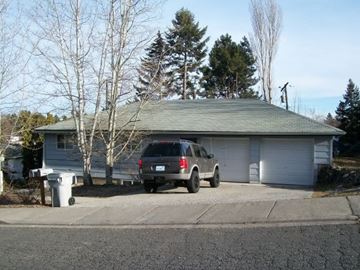 Pullman apartment for rent - A house with a garage and a car parked in front.