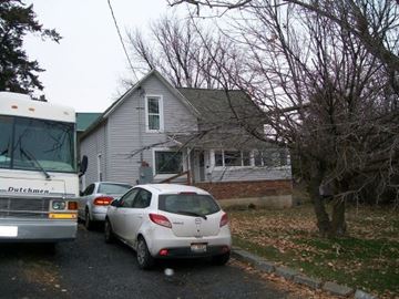 Pullman apartment for rent - A white car is parked in front of a house.