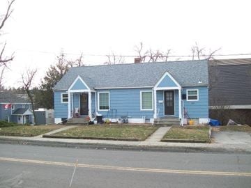 Pullman apartment for rent - A blue house with a black door and a small porch.