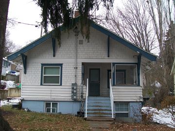Pullman apartment for rent - the front of a white house with a blue door