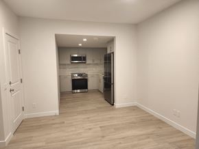 Edmonton apartment for rent - a renovated kitchen with white walls and wood flooring