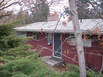 Pullman apartment for rent - A red house with a grey roof and a grey door.