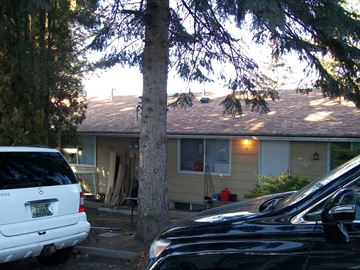 Pullman apartment for rent - A black car is parked in front of a house.