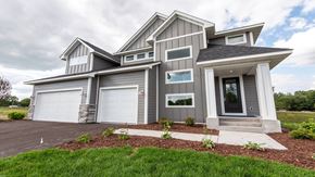 Dayton house for rent - A modern house with a grey and white exterior and a large front yard.