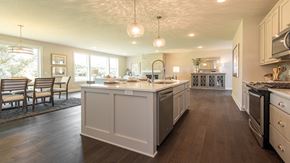 Dayton house for rent - A modern kitchen with white cabinets and a large island.