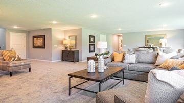 Dayton house for rent - A living room with a grey couch, a coffee table, and a painting on the wall.