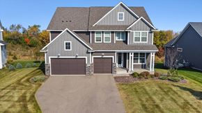 Lake Elmo house for rent - A large house with a grey roof and two garages.
