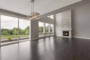 Lake Elmo house for rent - A modern living room with a fireplace and a chandelier.
