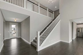 Lake Elmo house for rent - A spacious interior of a house with a staircase and a chandelier.