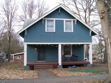Pullman apartment for rent - A blue house with a porch and lights on it.
