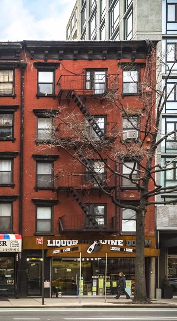 New York apartment for rent - a red brick building with a fire escape on the side