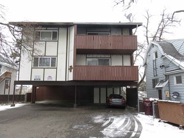 Pullman apartment for rent - A car is parked in the garage of a two-story apartment building.