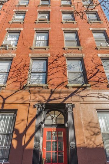 New York apartment for rent - the front of a brick building with a red door