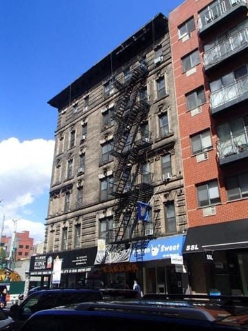 New York apartment for rent - a tall building with a fire escape on the side of it