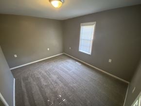 Clinton house for rent - an empty room with carpet and a window