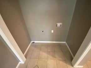 Clinton house for rent - a room with a tiled floor and walls and a light switch