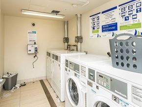 Waterloo apartment for rent - A laundry room with a washer and dryer stacked on top of each other.