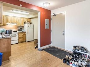 Waterloo apartment for rent - A kitchen with a white fridge and a white door.