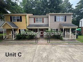 Garner apartment for rent - A sign for JW Hunter Company Inc. is in front of a building.