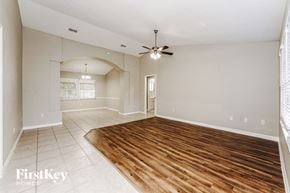 Palm Coast house for rent - a living room with a wooden floor and a ceiling fan